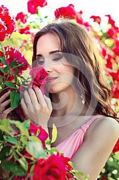 Portrait of a beautiful girl on a background of roses