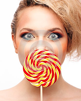 Portrait of beautiful girl with big lollipop