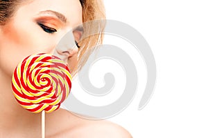 Portrait of beautiful girl with big lollipop