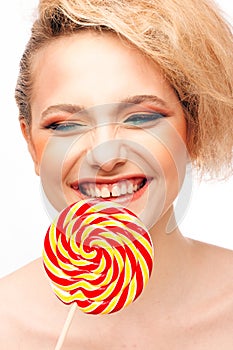 Portrait of beautiful girl with big lollipop