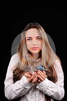 Portrait of beautiful girl with bird on the hand