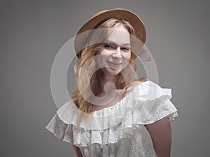 portrait of a beautiful girl with blue eyes on a gray background in the studio