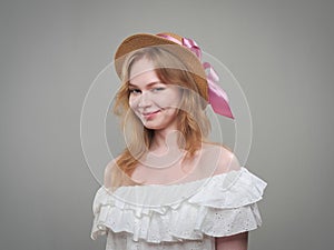 portrait of a beautiful girl with blue eyes on a gray background in the studio