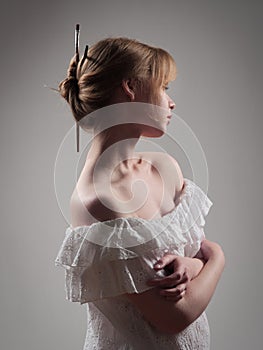 portrait of a beautiful girl with blue eyes on a gray background in the studio