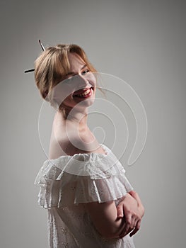 portrait of a beautiful girl with blue eyes on a gray background in the studio