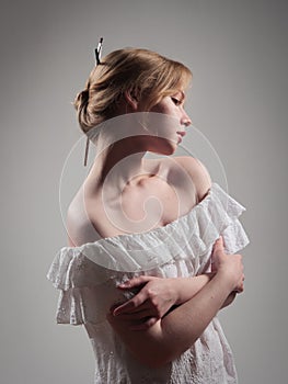 portrait of a beautiful girl with blue eyes on a gray background in the studio