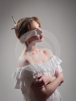 portrait of a beautiful girl with blue eyes on a gray background in the studio