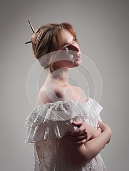 portrait of a beautiful girl with blue eyes on a gray background in the studio