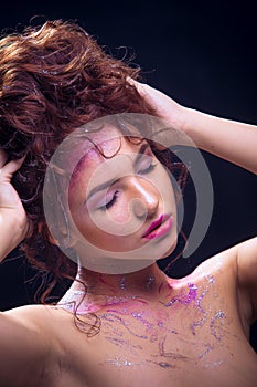 Portrait of a beautiful girl with bright makeup and hair