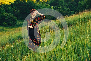 portrait of a beautiful girl with brown hair among the flowers in the field. summer holiday with flowers. countryside