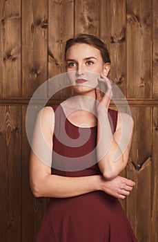 Portrait of a beautiful girl in a burgundy dress