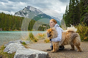 Portrait of the beautiful girl with chow-chow dog