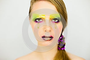 Portrait of beautiful girl with creative make up with glitters