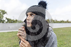 Portrait of a beautiful girl with dandelion flower