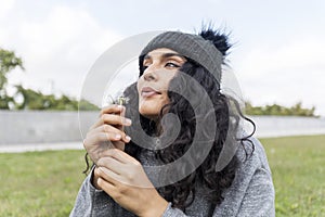 Portrait of a beautiful girl with dandelion flower