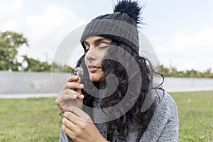 Portrait of a beautiful girl with dandelion flower