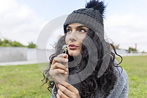 Portrait of a beautiful girl with dandelion flower