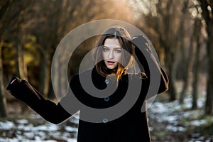 Portrait of a beautiful girl with flying hair in the wind. Young sad woman. Portrait of lonely woman