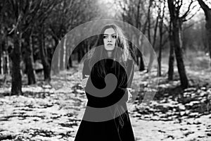 Portrait of a beautiful girl with flying hair in the wind. Young sad woman. Portrait of lonely woman