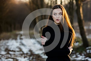 Portrait of a beautiful girl with flying hair in the wind. Young sad woman. Portrait of lonely woman