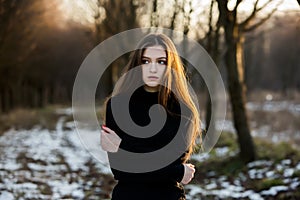 Portrait of a beautiful girl with flying hair in the wind. Young sad woman. Portrait of lonely woman