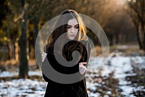 Portrait of a beautiful girl with flying hair in the wind. Young sad woman. Portrait of lonely woman