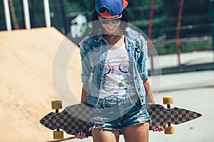 Portrait of beautiful girl in glasses and cap looking