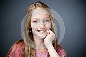 Portrait of a beautiful girl on a gray background