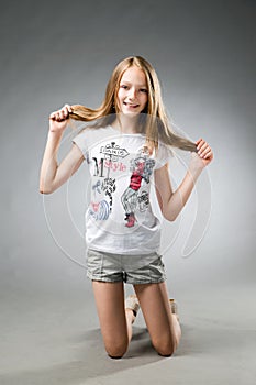 Portrait of a beautiful girl on a gray background