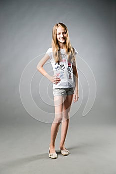 Portrait of a beautiful girl on a gray background