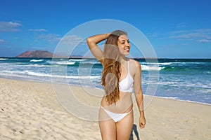 Portrait of beautiful girl have fun on Corralejo Dunas beach in Fuerteventura, Canary Islands