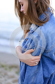 Portrait of beautiful girl with light smile on lips that poses o