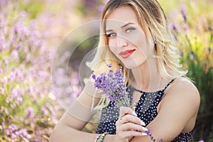 Portrait of beautiful girl lying on the lavender field