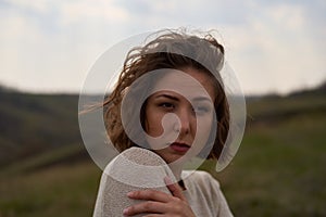 Portrait of beautiful girl on nature view background with hills and sky, isolated