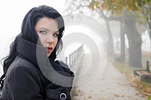 Portrait of beautiful girl outdoor on misty autumn day