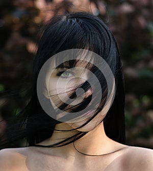 Portrait of beautiful girl outdoor on windy spring day