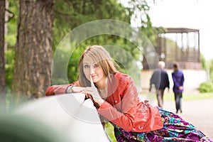 Portrait of a beautiful girl on a park bench