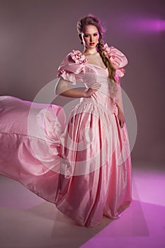 Portrait of a beautiful girl in a pink dress,