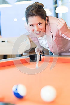 Portrait beautiful girl playing billiard