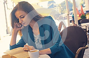 Portrait of a beautiful girl reading book