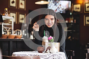 Portrait of a beautiful girl reading book in cafe