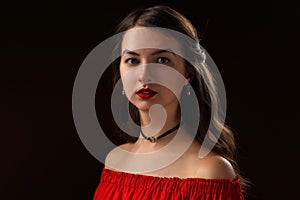 Portrait of a beautiful girl in a red blouse