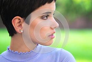 Portrait of beautiful girl with short hair outdoor