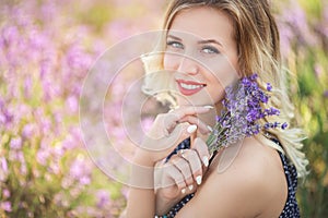 Portrait of beautiful girl sitting in lavender field