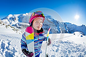 Portrait of a beautiful girl with ski in mountains