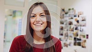 Portrait of beautiful girl smiles for camera and gives thumbs up