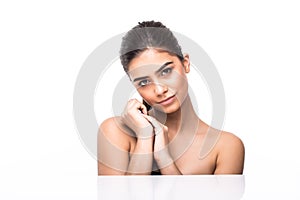 Portrait of beautiful girl stroking her pretty face with healthy skin white background