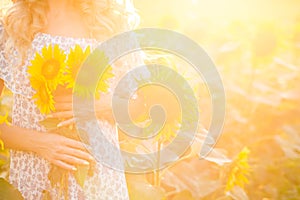 Portrait of the beautiful girl with a sunflowers