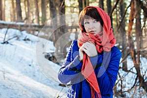 Portrait of a beautiful girl Sunny in the afternoon in the winter forest, a lot of bright sun