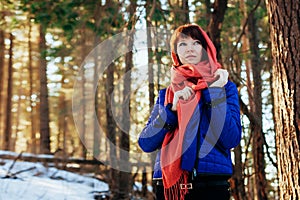 Portrait of a beautiful girl Sunny in the afternoon in the winter forest, a lot of bright sun